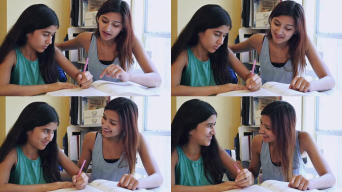 年轻女子在学习时鼓励妹妹辅导她