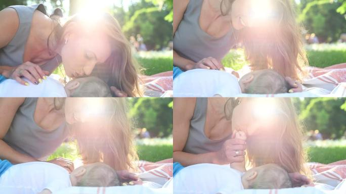 快乐的母亲带着她的孩子在公园