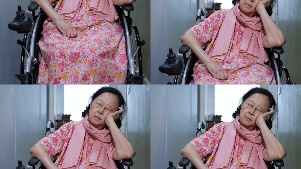 亚洲高级妇女在轮椅上打瞌睡