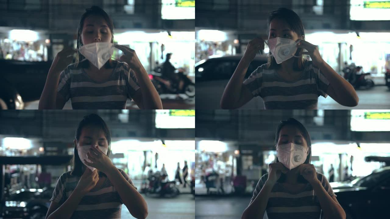 晚上有口罩保护的女人免受空气污染