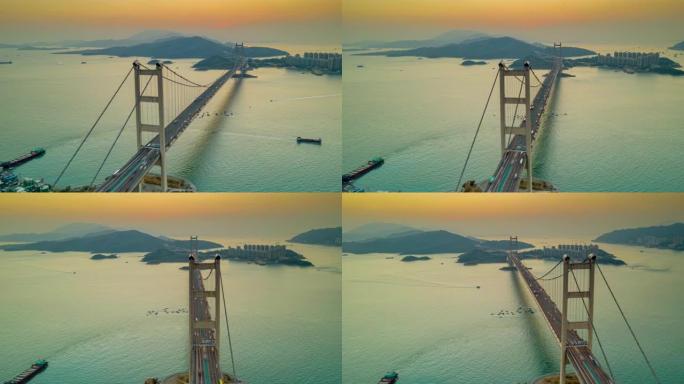 日落时香港青衣区马大桥的汽车交通超视或俯冲鸟瞰图。日夜延时