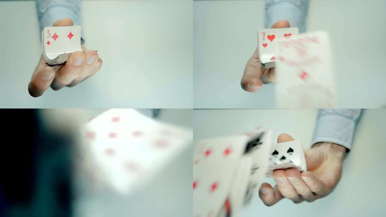 手挤压一副扑克牌，它们弯曲并向前飞