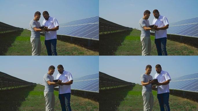 两名商人走在一排排太阳能电池中