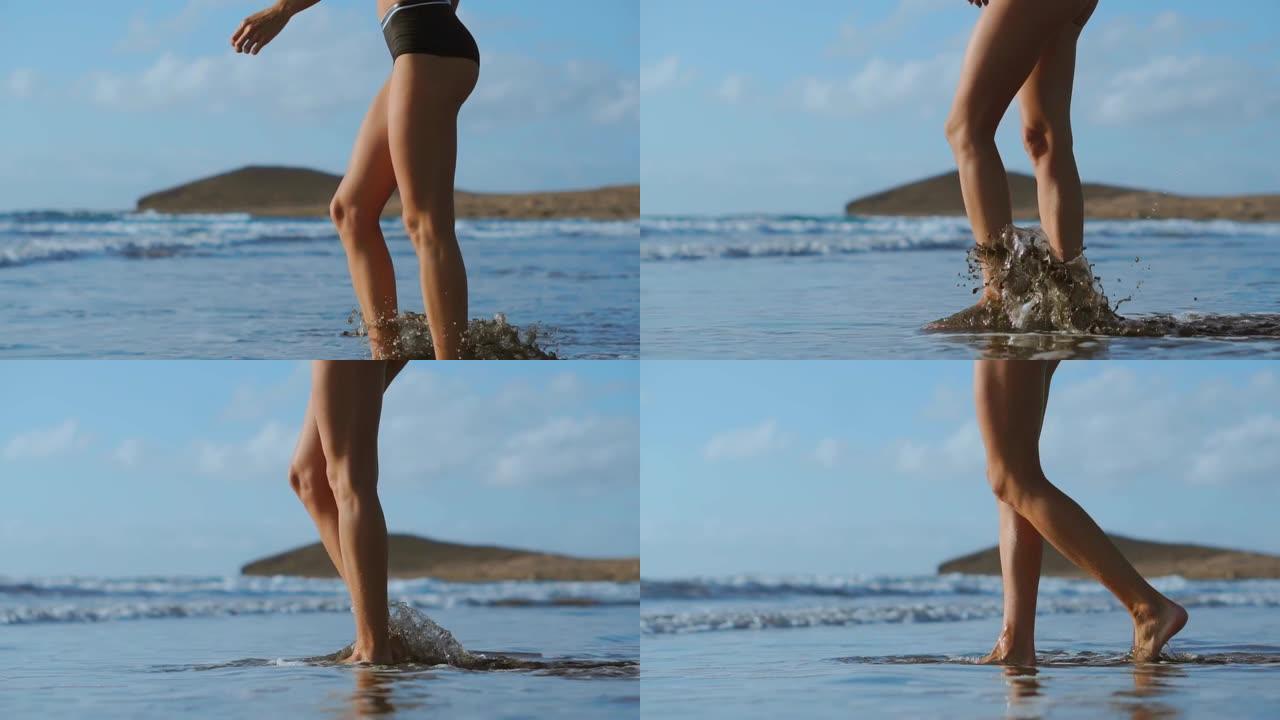 一个女人赤脚在海滩上走的特写，进入大海。慢镜头替身