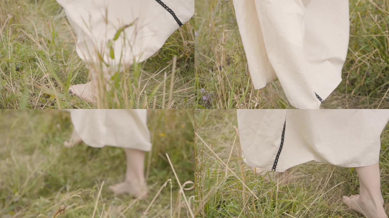 光着脚的女人在白色长裙走过田野特写。