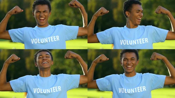 可爱的少年志愿者做出强烈的手势，并对相机微笑，慈善事业