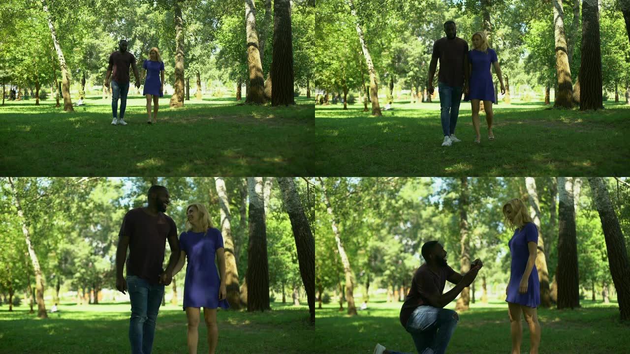 在公园惊喜订婚，跪着的男人与戒指求婚，幸福的夫妻