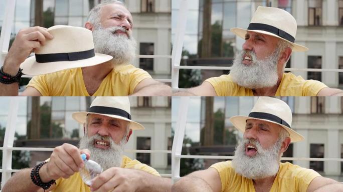 一个大胡子的老人戴着帽子扇风
