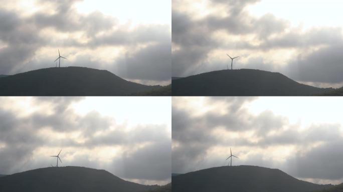 风力涡轮机在森林的山脊上旋转