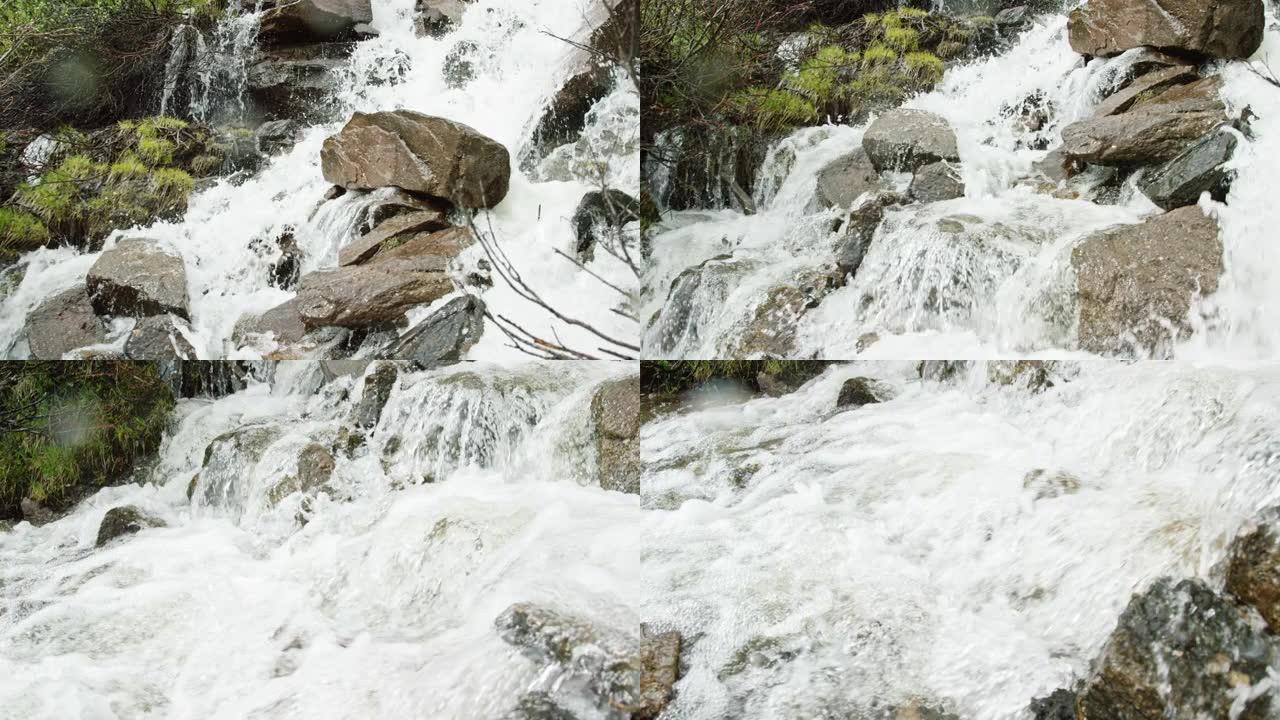 来自山涧的水以慢动作落在岩石和巨石上