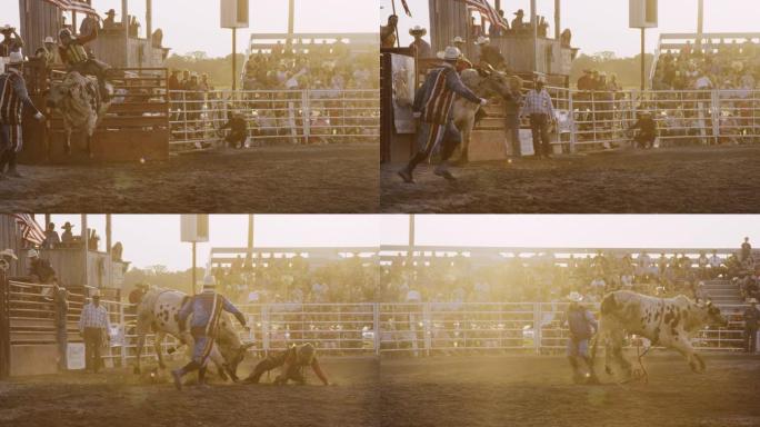 一名男公牛骑手参加公牛比赛的慢动作镜头，然后在日落时分被人从体育场的公牛背上扔出