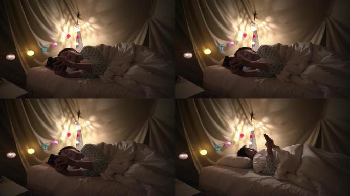 女人躺在床上看智能手机上的视频