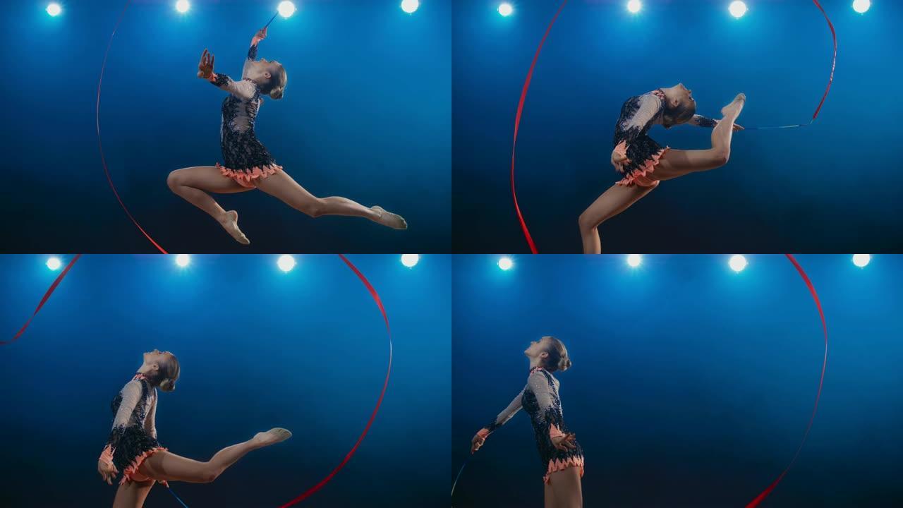 SLO MO SPEED RAMP LD艺术体操运动员在进行雄鹿飞跃时用红丝带进行大挥杆