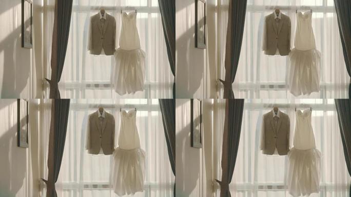 挂在窗前的婚纱和西装