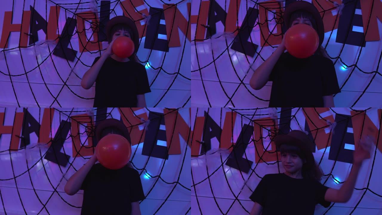 男孩在万圣节派对上吹气球