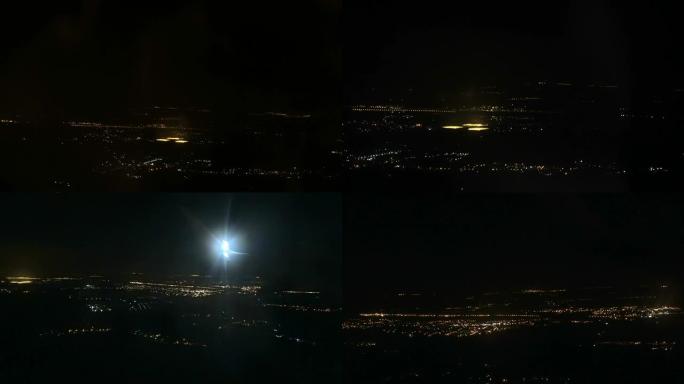 夜市的灯光穿过飞行飞机的舷窗