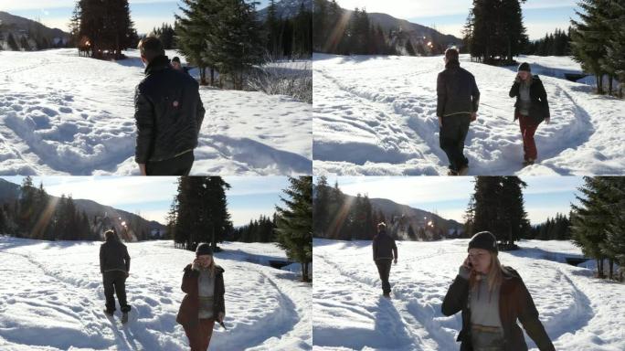 年轻男女沿着白雪皑皑的小径行走
