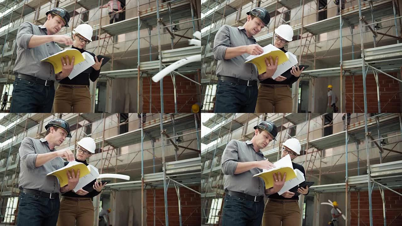 男女建筑师站在建筑物外进行施工，并在数字平板电脑上检查计划