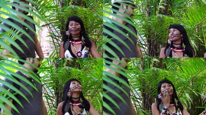 来自瓜拉尼族的巴西土著年轻女子向游客展示雨林