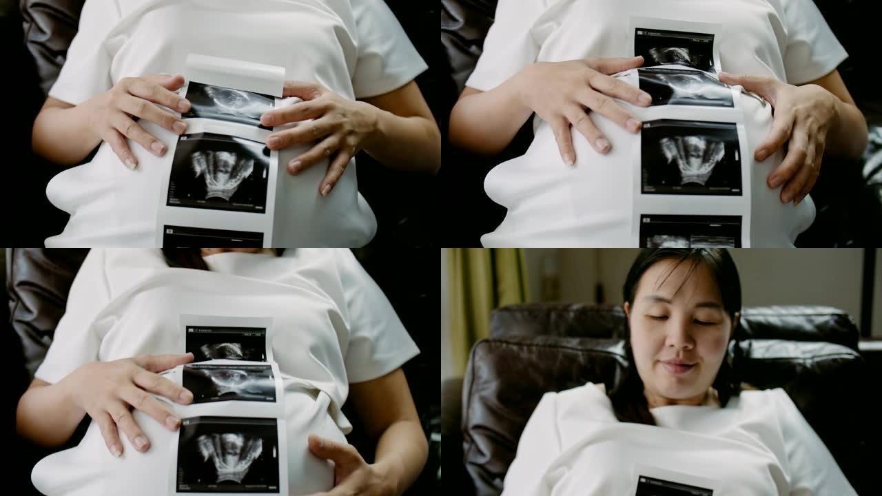 亚洲孕妇显示婴儿的超声图像
