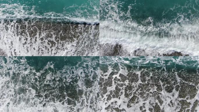 鹅卵石上滚滚的泡沫清澈的波浪。圆石滩上地中海海水的俯视图。塞浦路斯旅游胜地阳光明媚的海岸。特写。海景