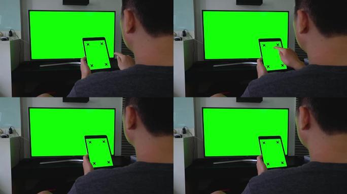 数字平板电脑和电视的肩拍，绿屏