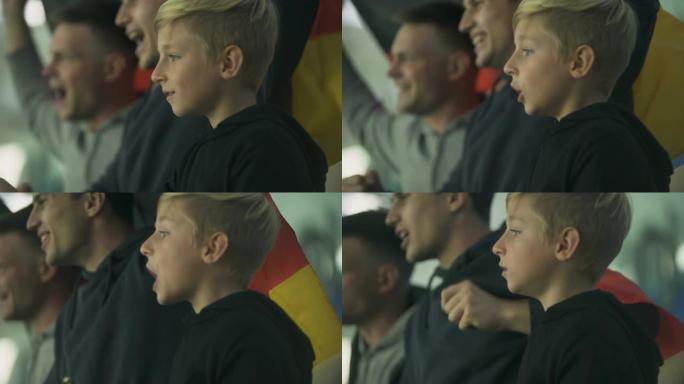 儿童和成人的德国球迷挥舞旗帜，在体育场为足球队欢呼