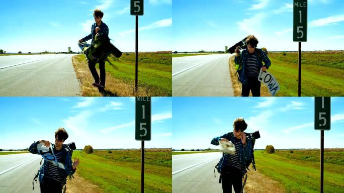 年轻人，搭便车的人，试图在美国伊利诺伊州的高速公路上停车去爱荷华州。