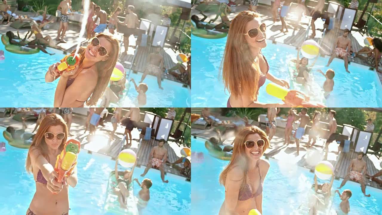 在泳池派对上，穿着比基尼的SLO MO年轻女子将喷水器中的水射到镜头中，然后大笑