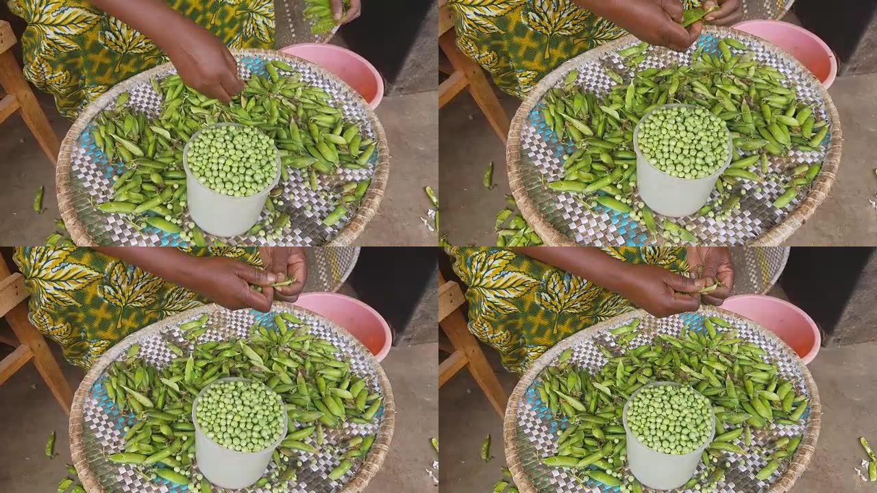 非洲妇女的手剥豌豆