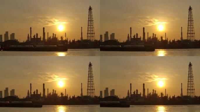 4K分辨率炼油厂在清晨日出时用反射剪影结构的烟囱释放烟气