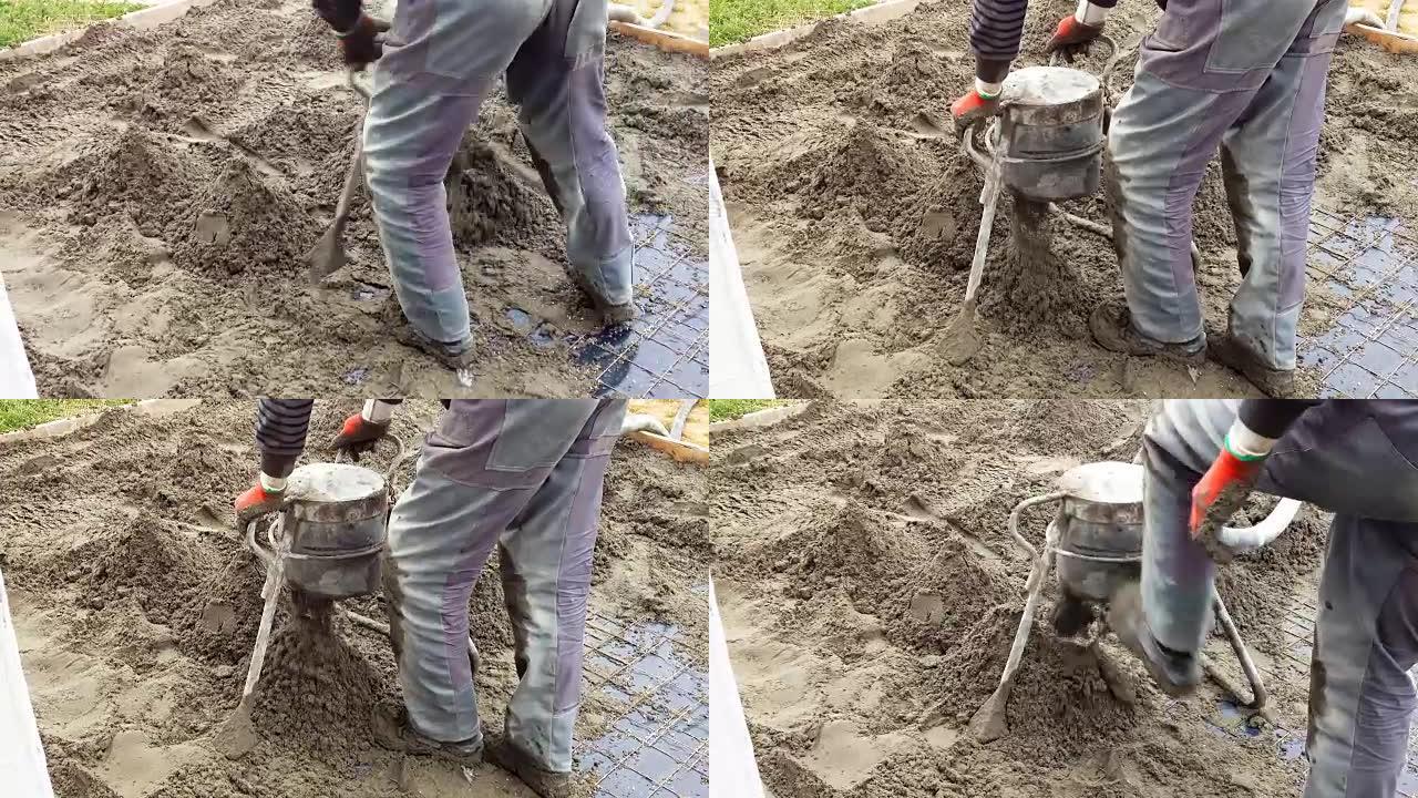 员工进行沙子和水泥熨平地板。沙子和水泥地板熨平板