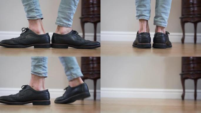 黑色broggi靴子的特写镜头转向两侧。无法辨认的高加索成年男子转脚离开。鞋类，配饰，时尚。