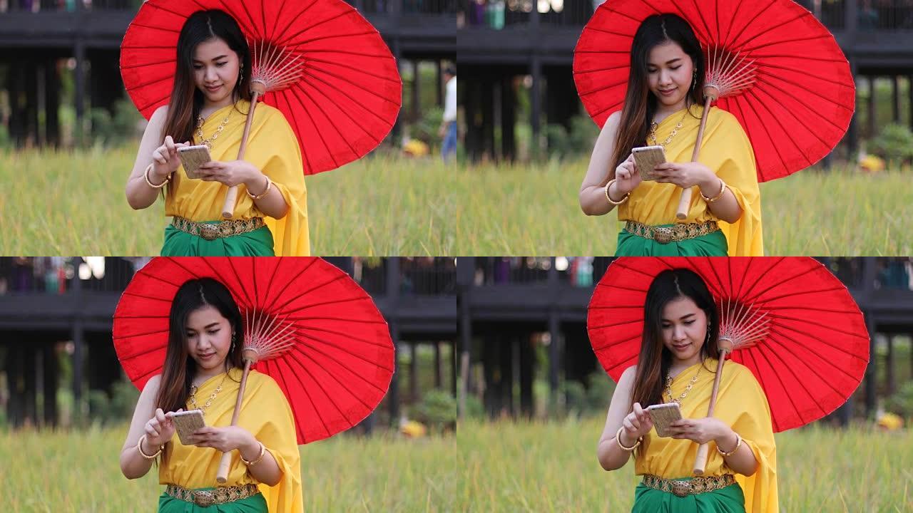 泰国女人穿着传统风格的手机