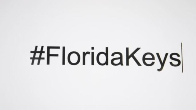 一个人在他们的电脑屏幕上输入 “# FloridaKeys”