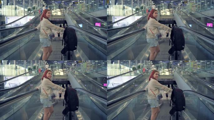 4k镜头旅客拖着行李，朝机场的自动扶梯走去