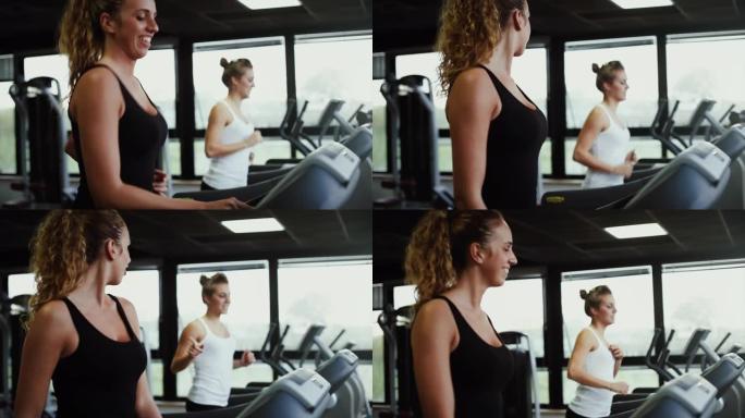 有氧运动机器上的年轻女性: 在健身房进行艰苦训练