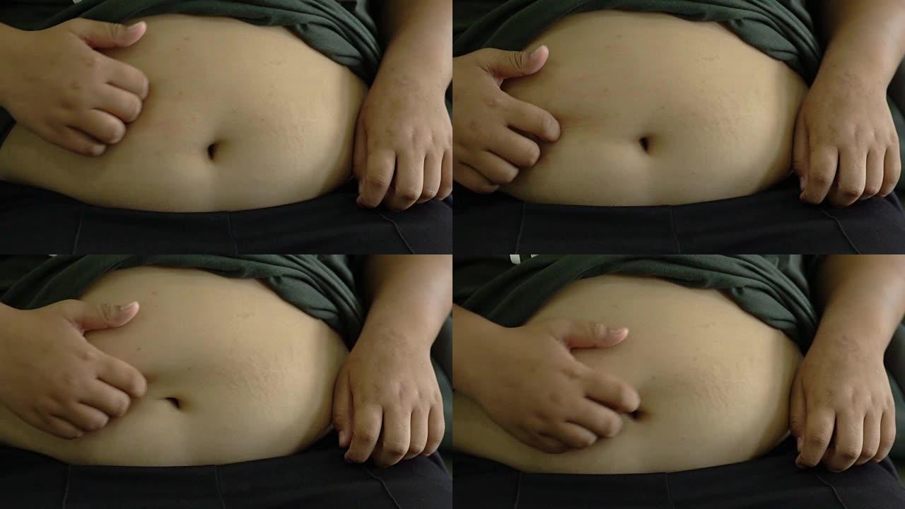 慢动作亚洲男孩胖抓肚子用手高清。