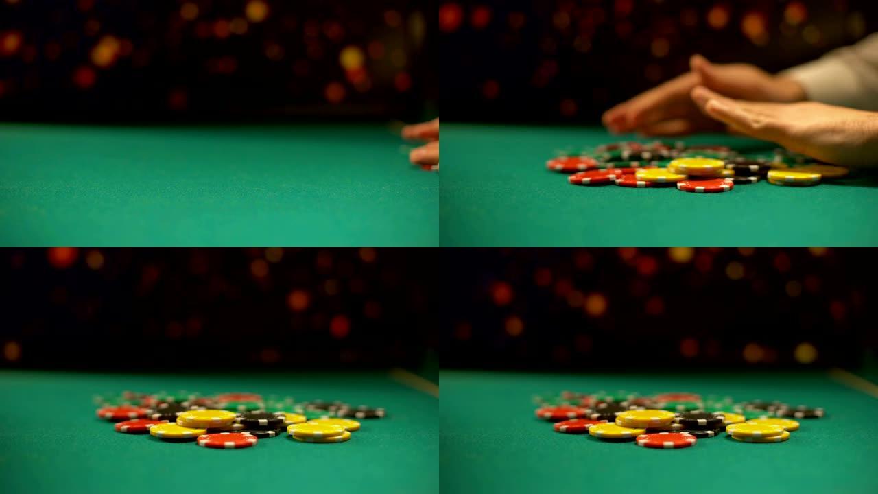 绝望的赌场玩家将赌博筹码放在桌上，全押，扑克游戏