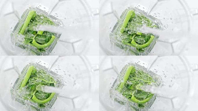 SLO MO LD将水倒入带有绿色蔬菜的搅拌机中