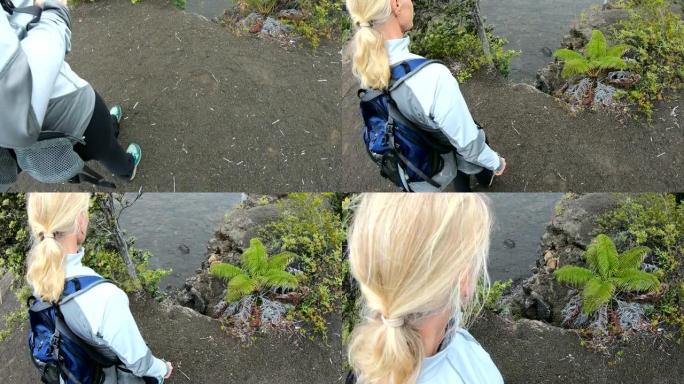 POV女人穿着背包走到火山岩上