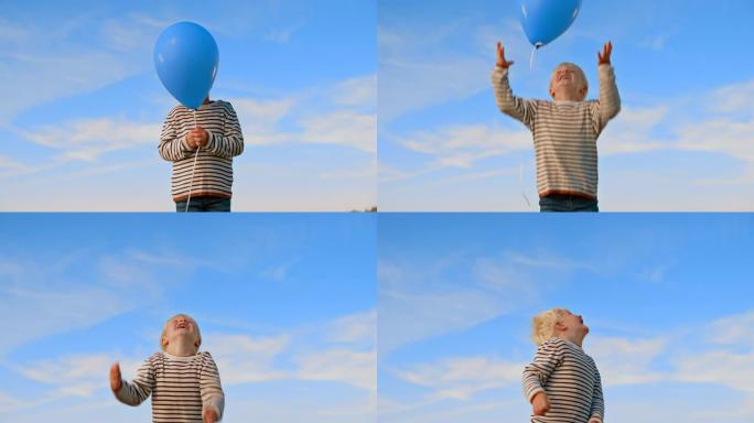 SLO MO金发小男孩放开气球，仰望天空