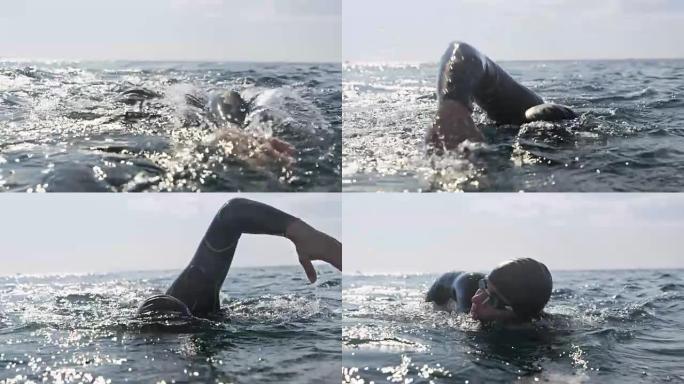 SLO MO男游泳运动员在海上晴天以向前爬行技术游泳