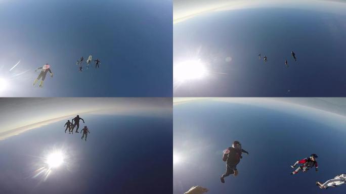 跳伞运动员从直升机上跳下来，进行空中杂技表演