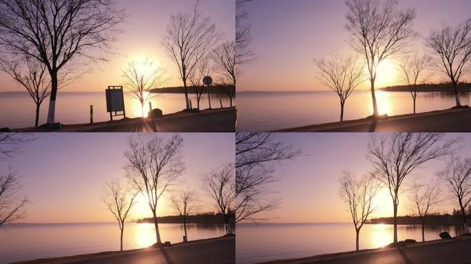 驱车行驶在湖泊边的夕阳日落风光