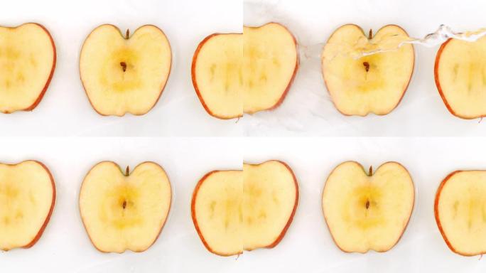 3苹果躺在白色背景上慢动作落水飞溅