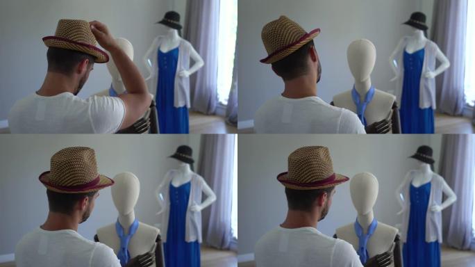 年轻人把帽子戴在头上看着男性模特的后视图。
