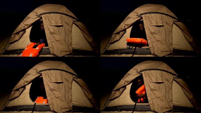 战争难民在帐篷中拥抱救生衣，不断感到危险