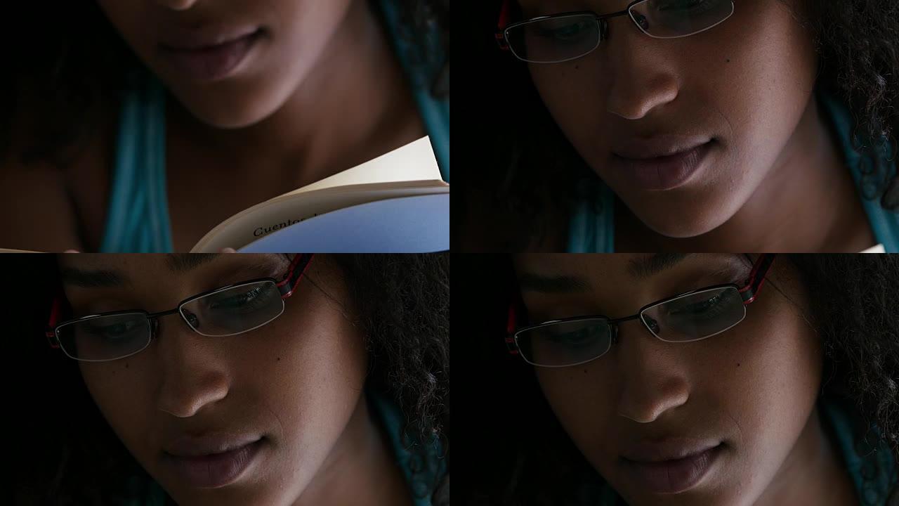美丽的黑人妇女读一本书的特写