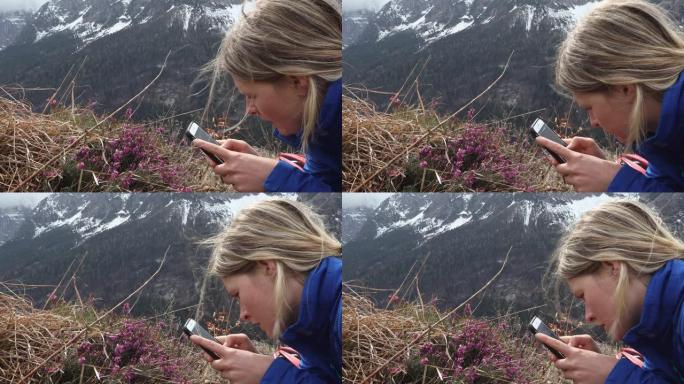 年轻女子拍摄高山花卉的智能照片